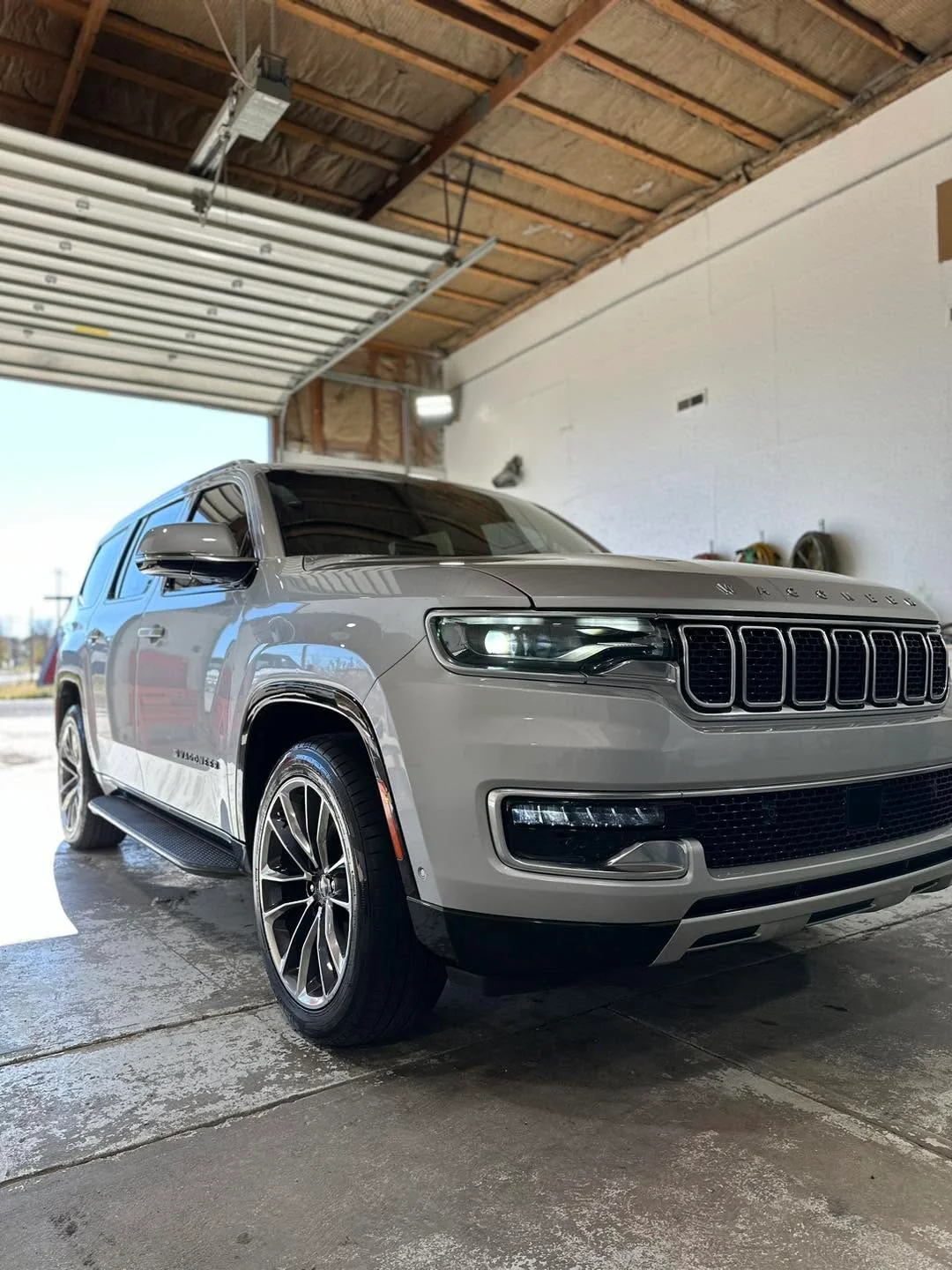 Gray Jeep Wagoneer SUV, front three-quarter view