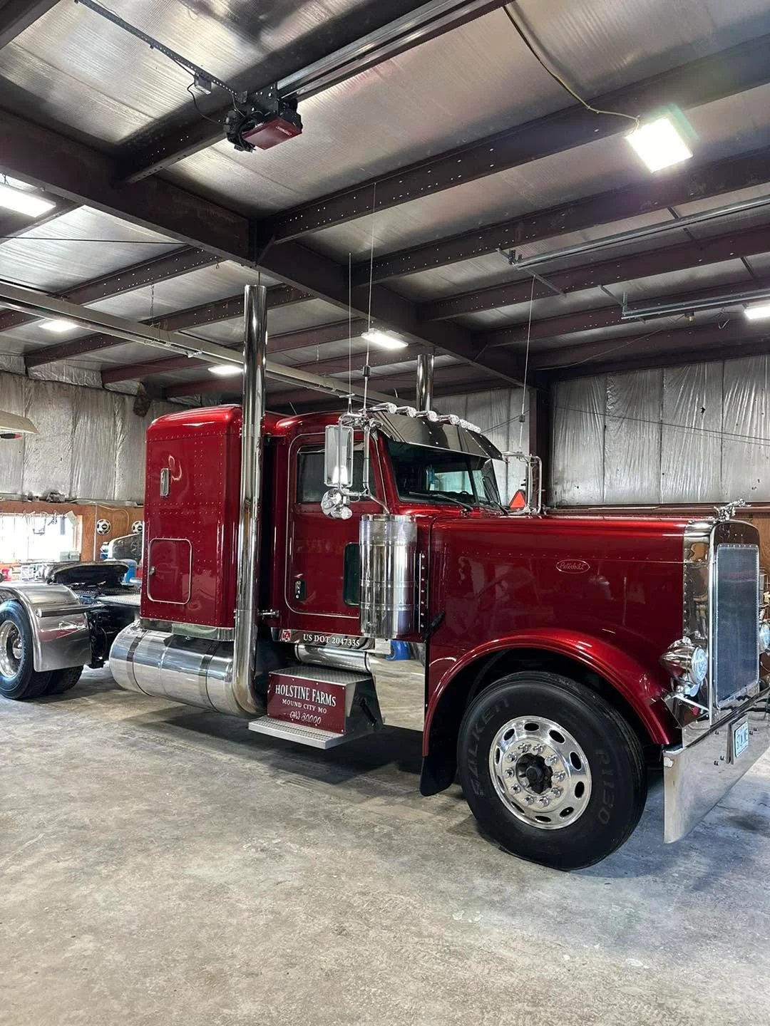 Dark red Peterbilt semi-truck cab, side profile view