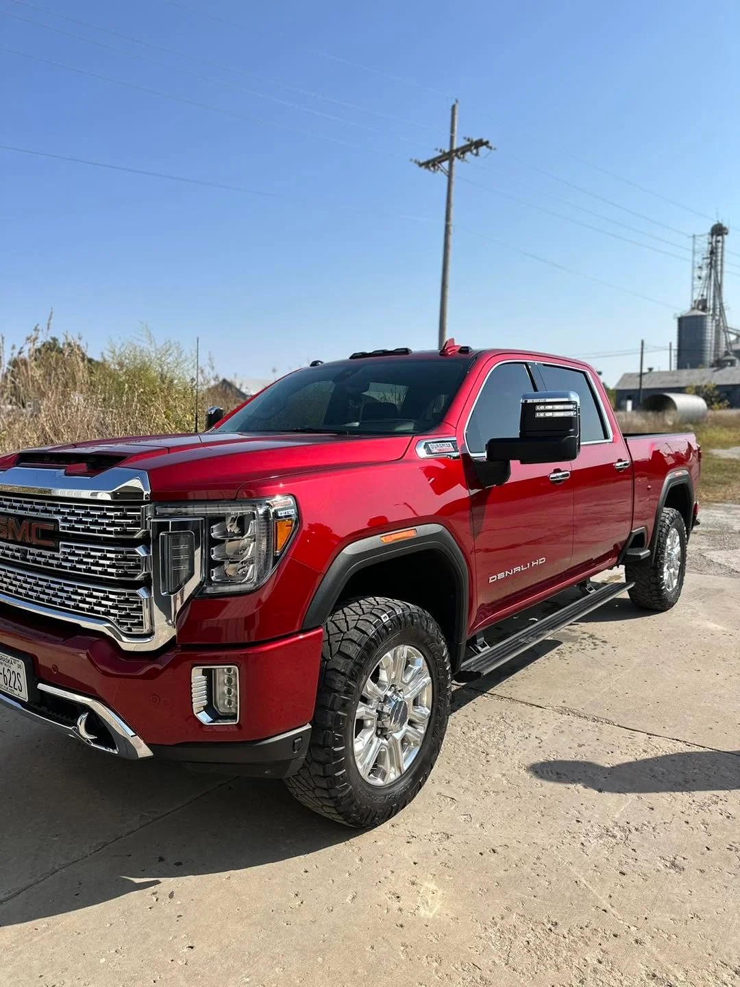 Red GMC Denali HD pickup truck, front three-quarter view