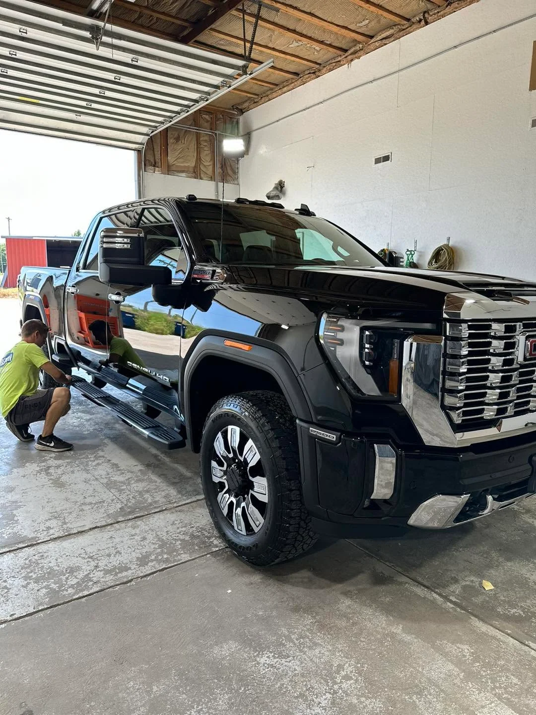 Black GMC Denali HD pickup truck, front three-quarter view