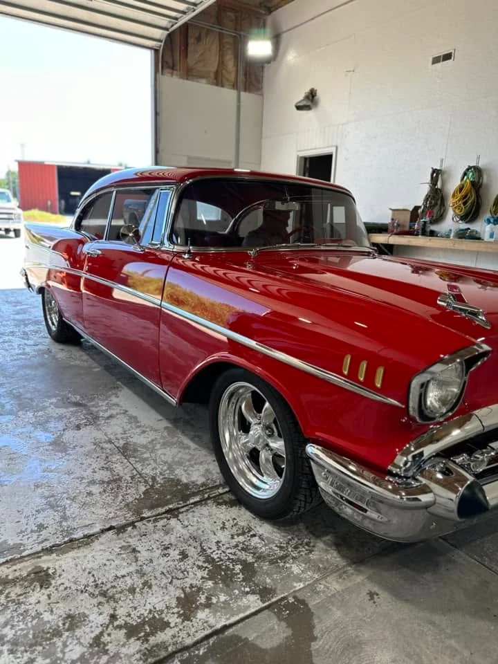 Red 1957 Chevrolet Bel Air, side three-quarter view