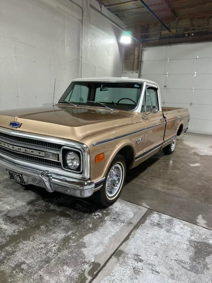 Tan 1970 Chevrolet C10 pickup, front three-quarter view in garage