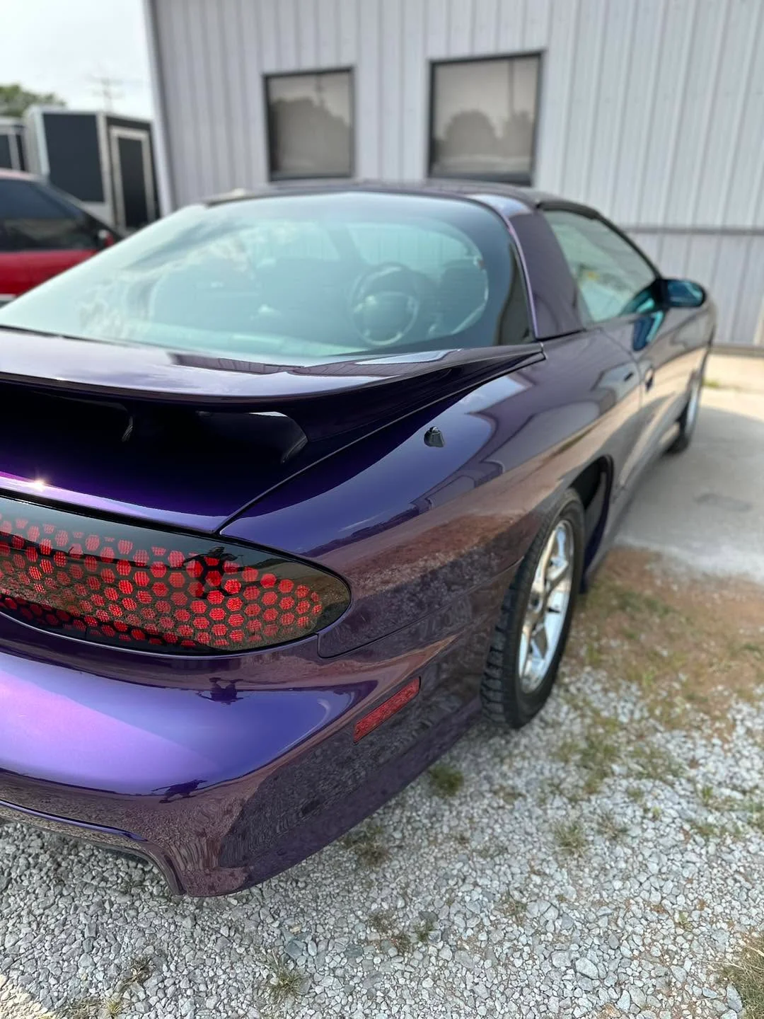 Purple Pontiac Firebird, rear three-quarter view