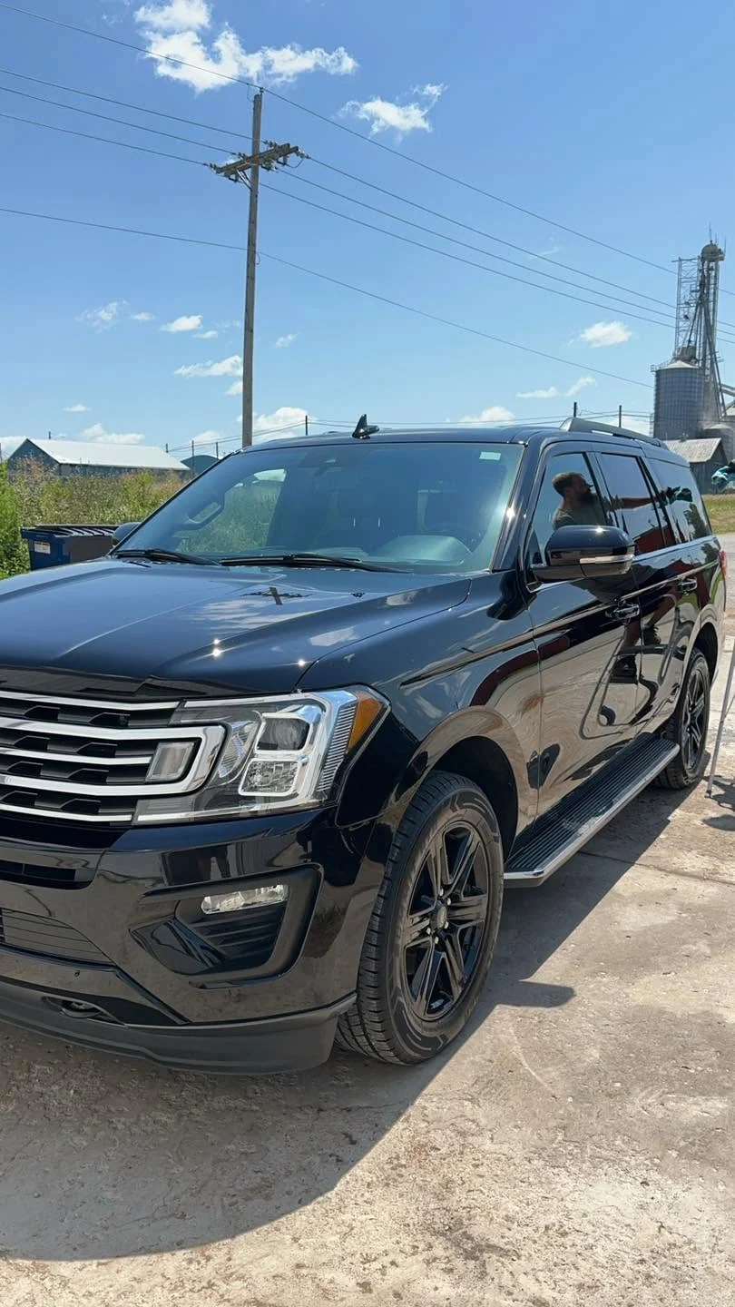 Black Ford Expedition SUV, front three-quarter view