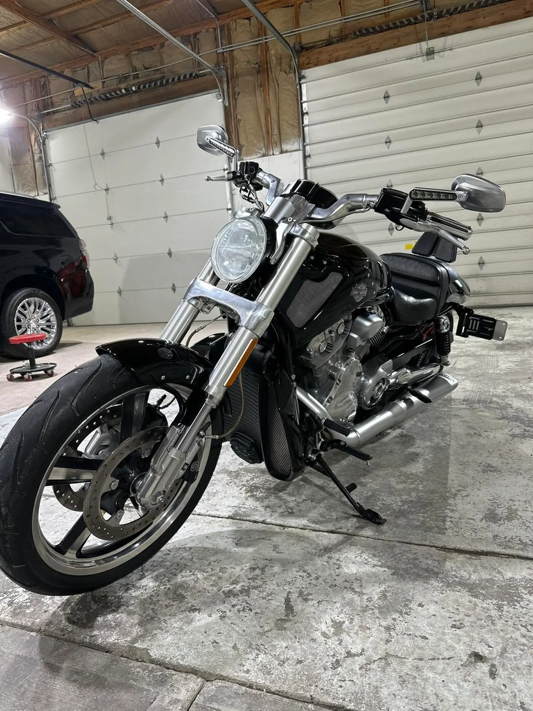 Black Harley-Davidson V-Rod motorcycle, front three-quarter view in garage