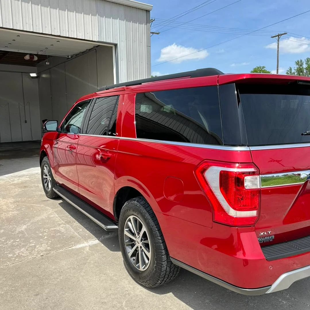 Red Ford Expedition XLT SUV, rear three-quarter view