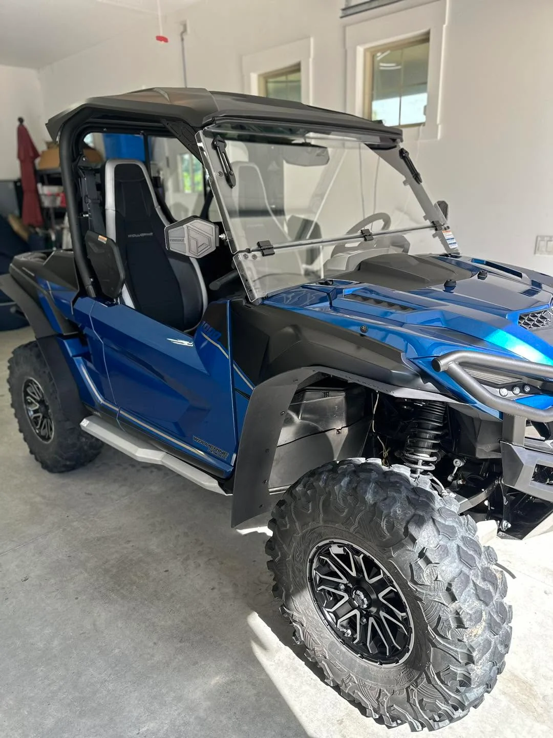 Blue Yamaha Wolverine UTV side-by-side, front three-quarter view
