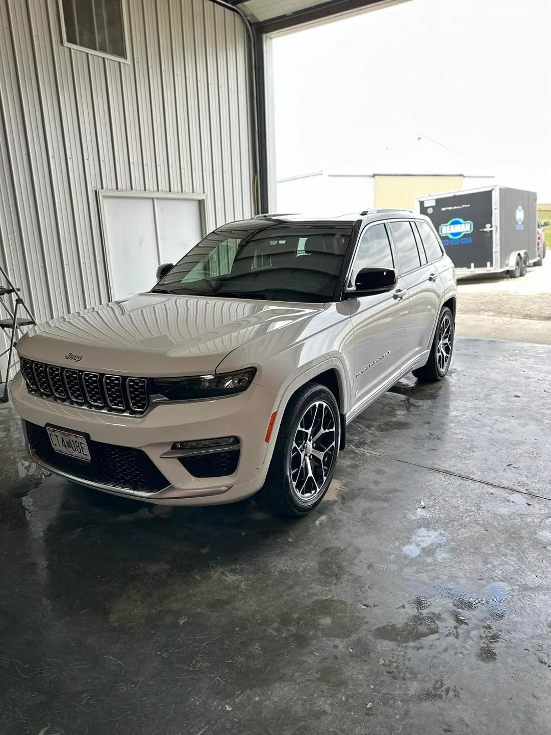 White Jeep Grand Cherokee Summit SUV, front three-quarter view