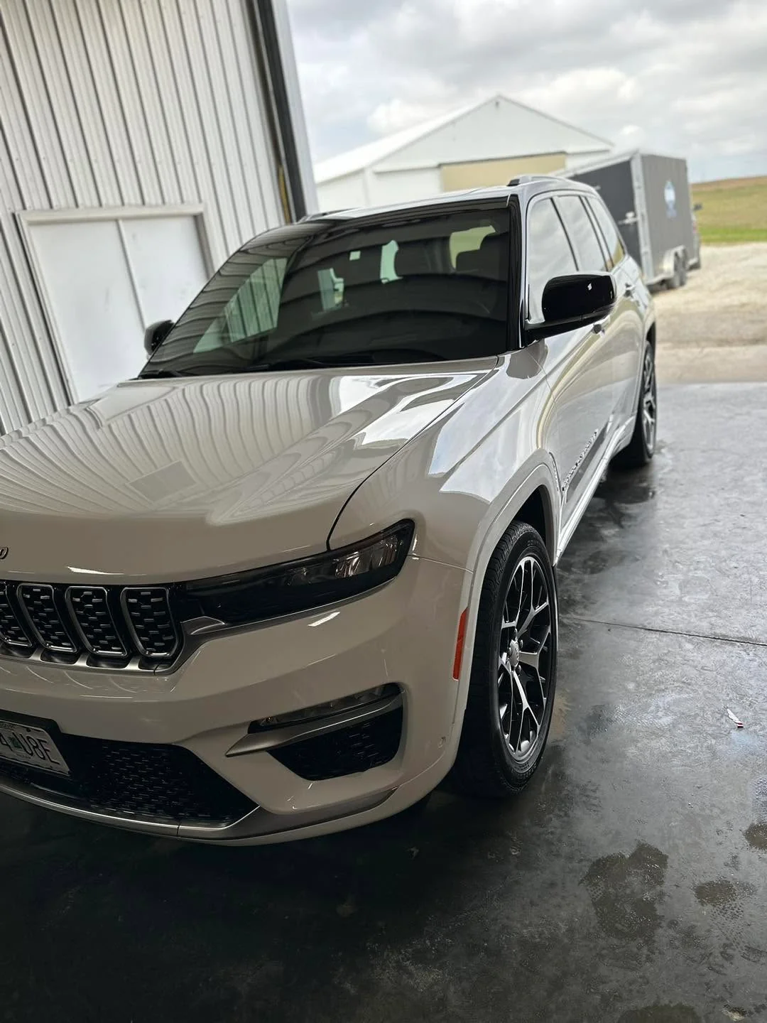 White Jeep Grand Cherokee SUV, front three-quarter view