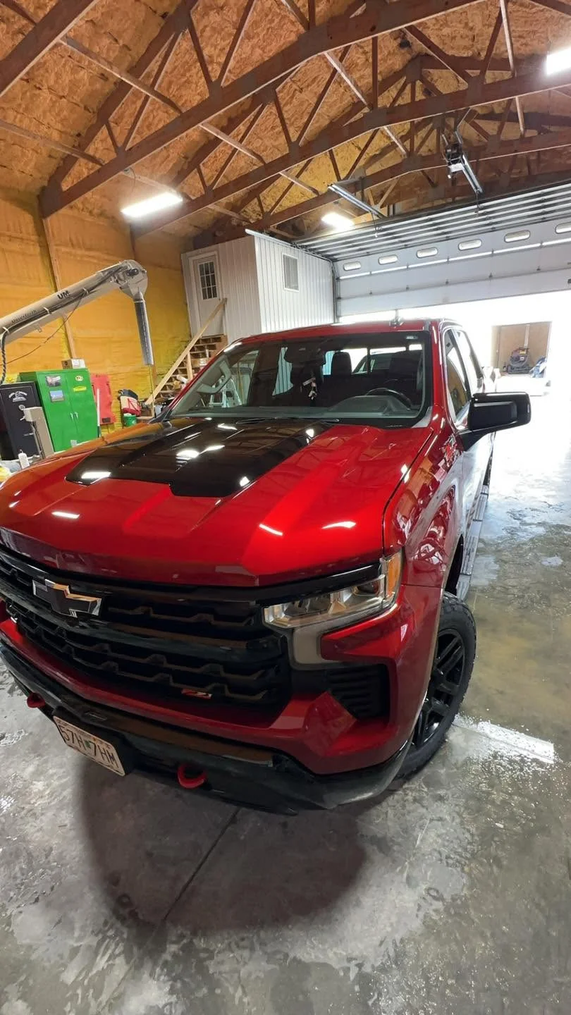 Red Chevrolet Silverado Z71 pickup, front three-quarter view indoors