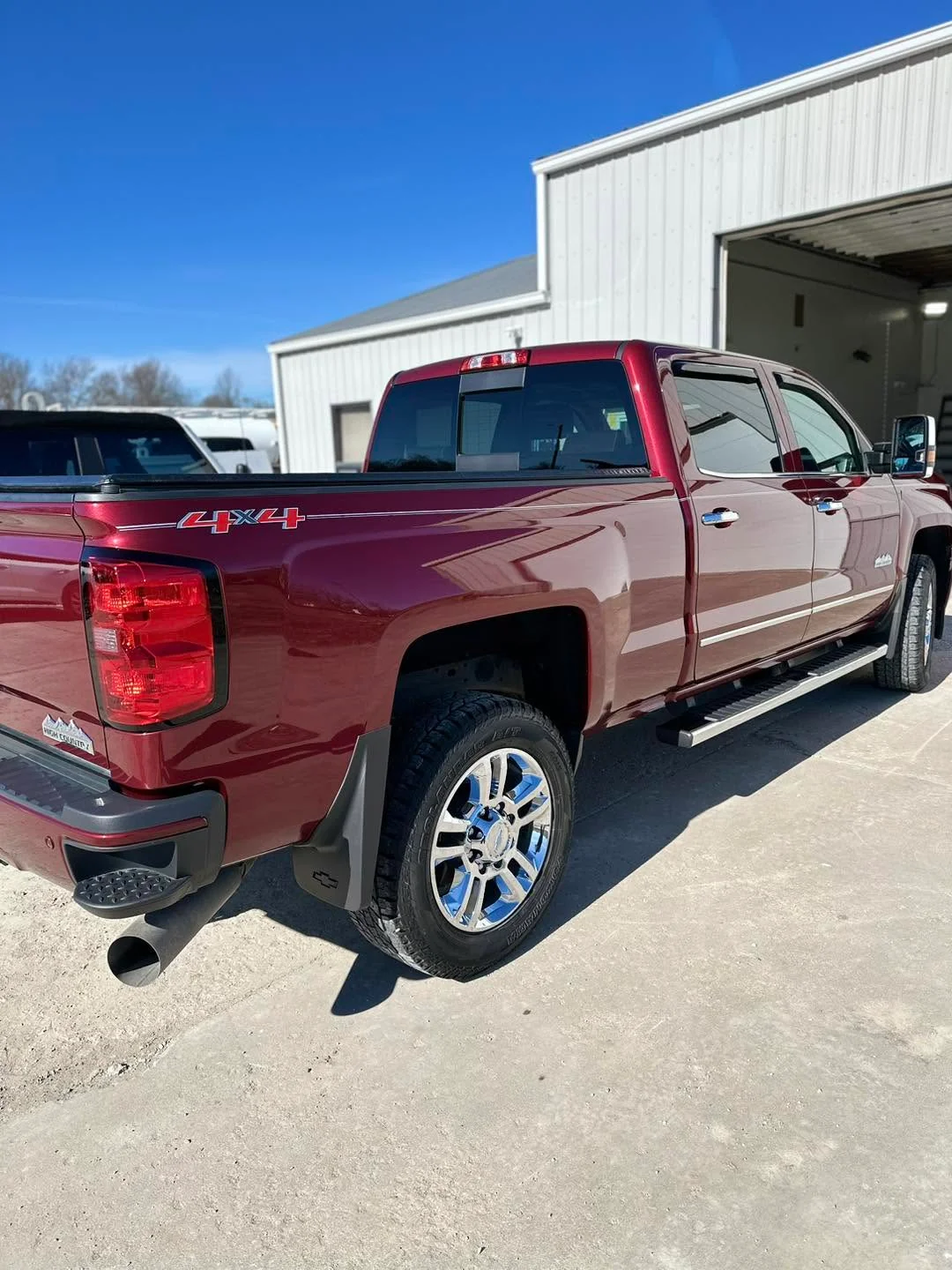 Maroon Chevrolet Silverado High Country 4x4 pickup, rear three-quarter view