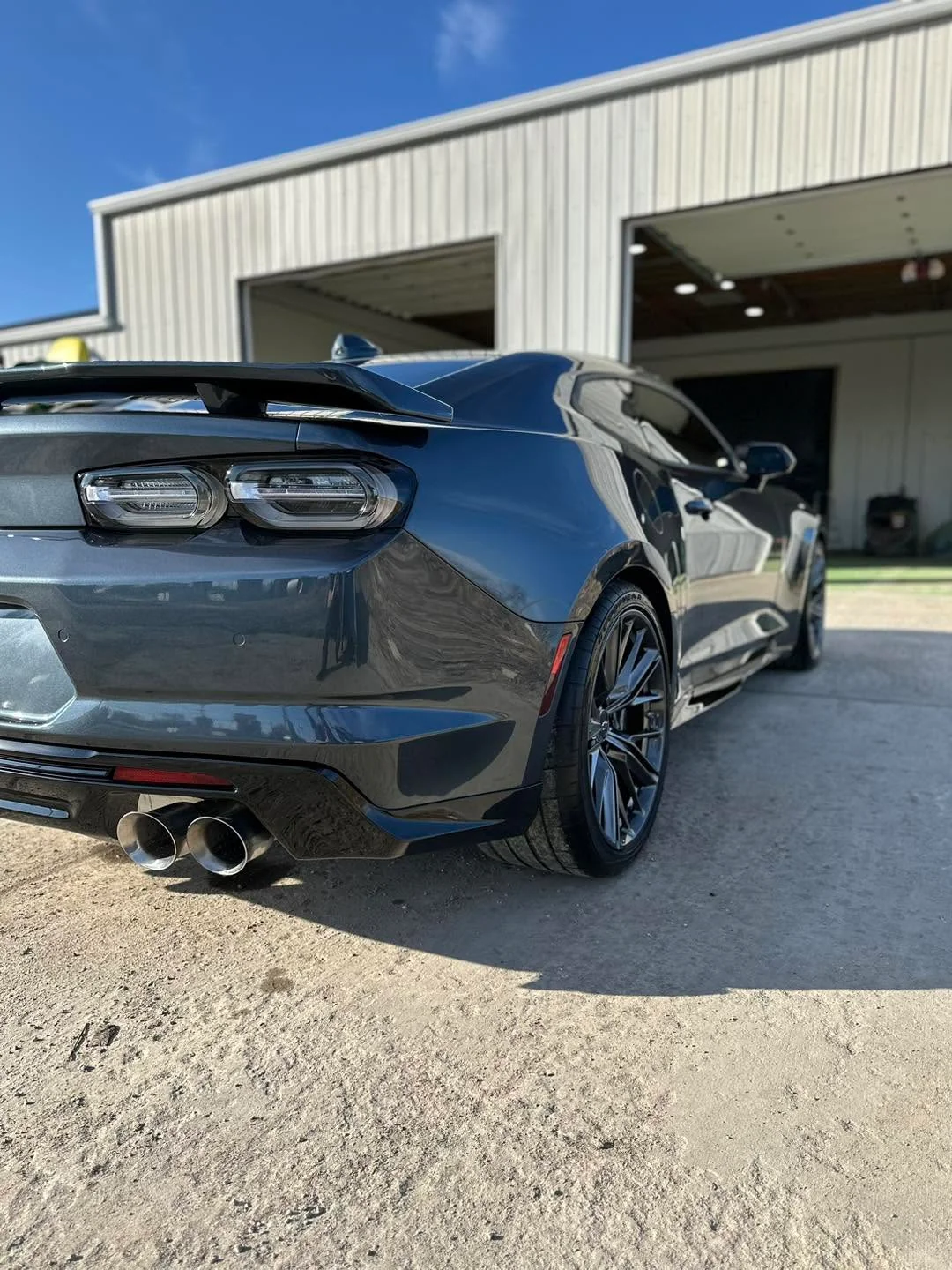 Dark gray Chevrolet Camaro coupe, rear three-quarter view