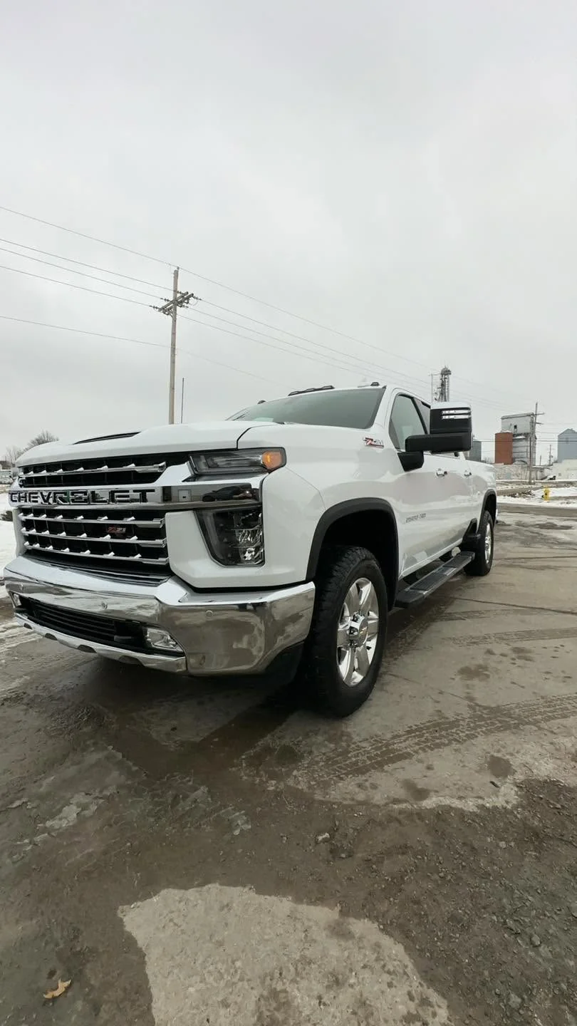White Chevrolet Silverado HD pickup truck, front three-quarter view