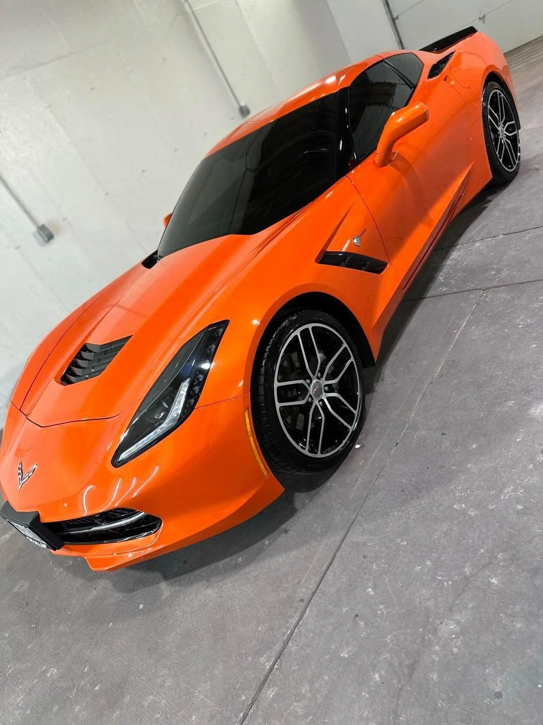 Orange Chevrolet Corvette C7 coupe, front three-quarter view