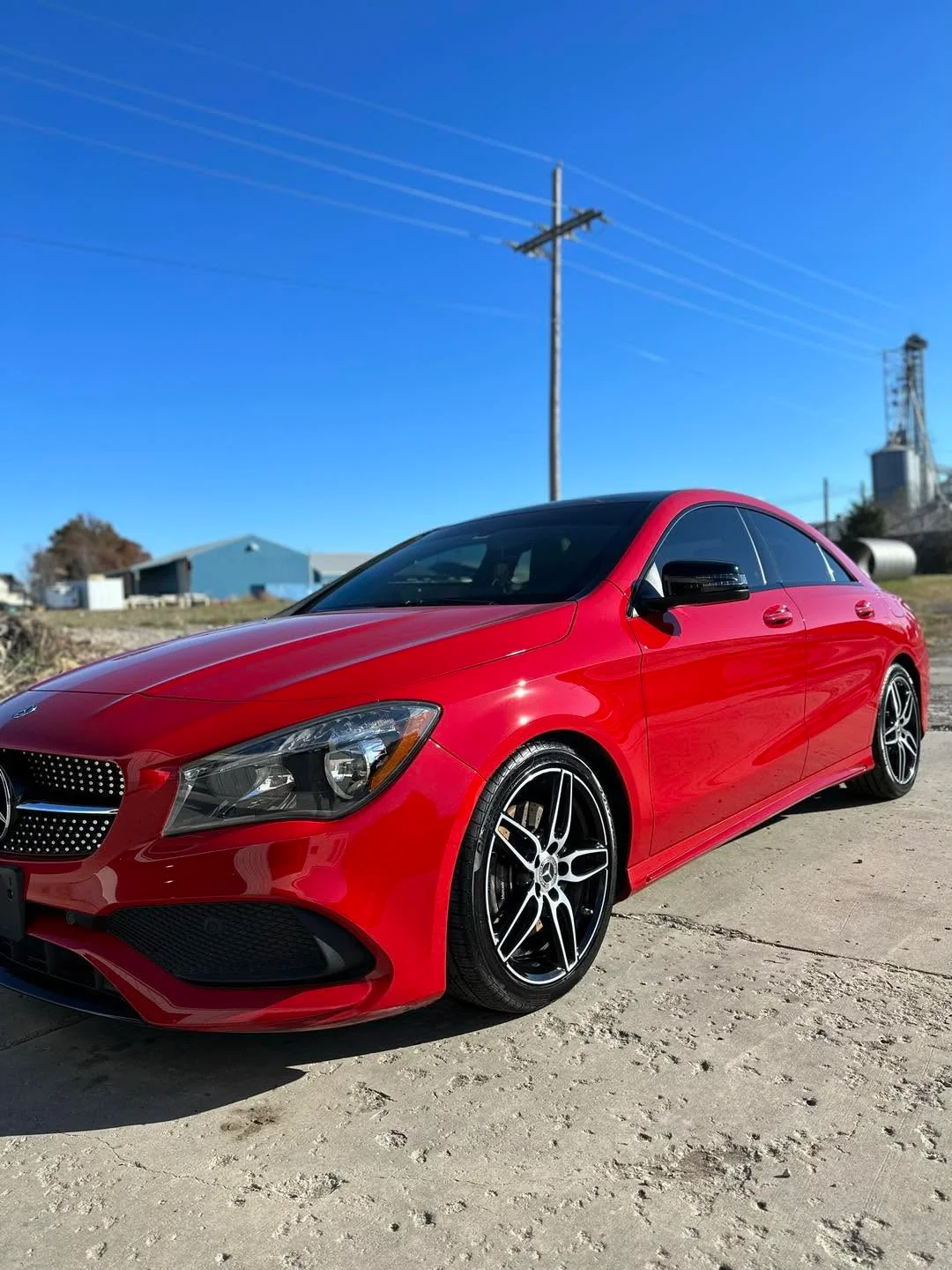 Red Mercedes-Benz CLA sedan, front three-quarter view outdoors