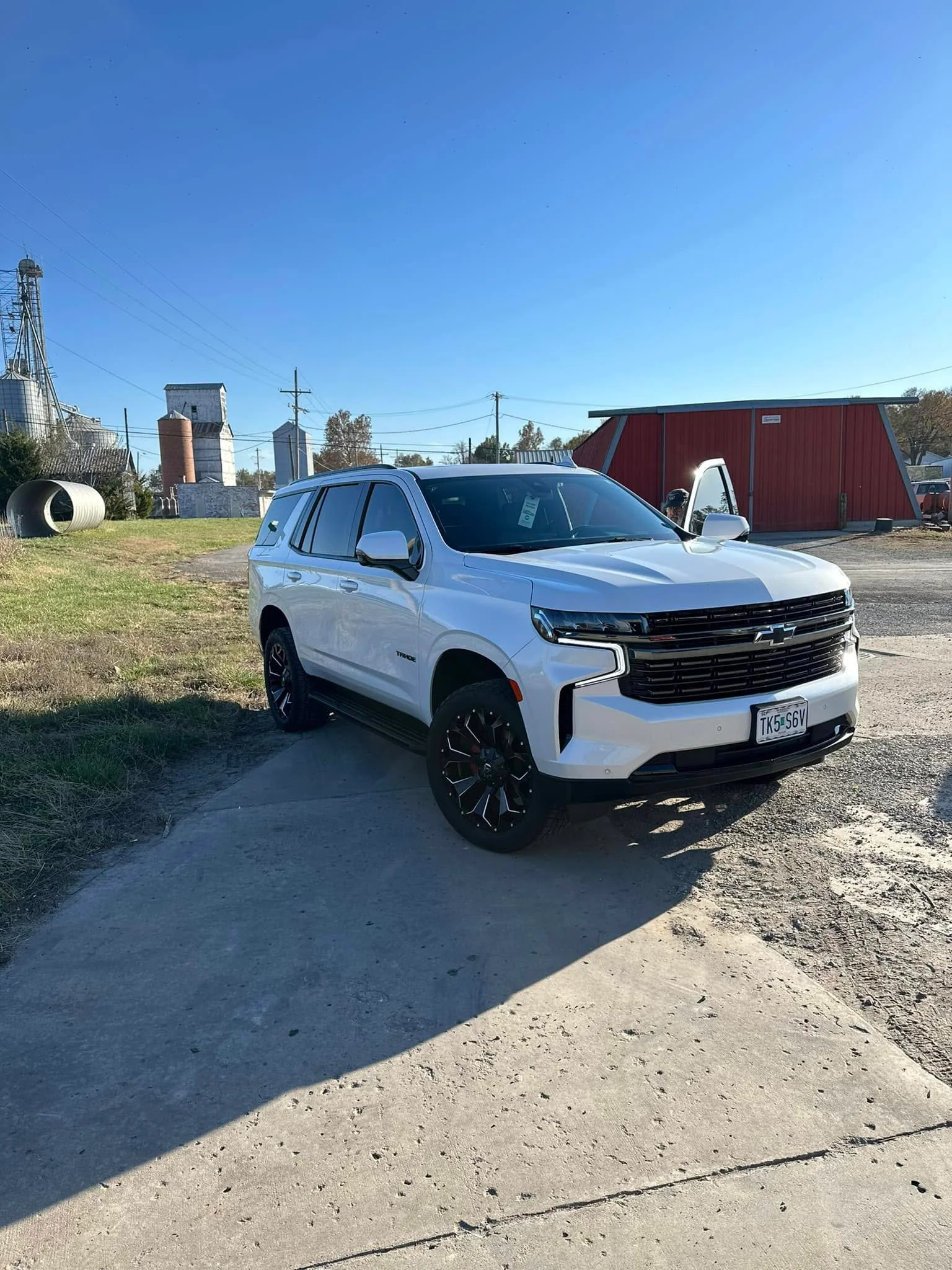 White Chevrolet Tahoe SUV, front three-quarter view outdoors